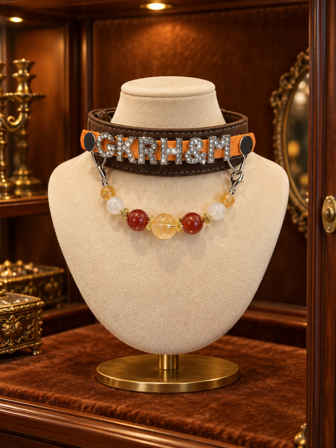 Namepiece collar presented in a jewellery cabinet